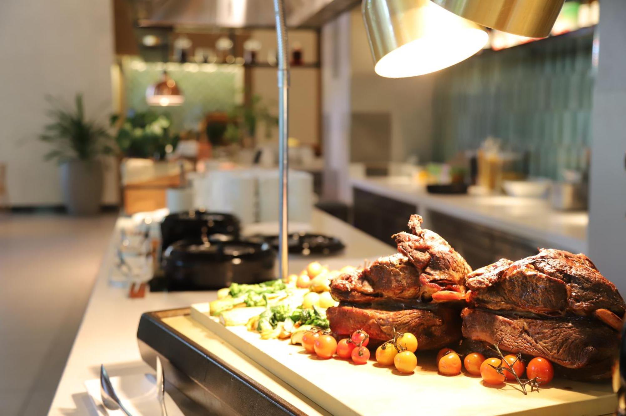 Melia Hanoi Exterior photo A carving station with a meat carving knife
